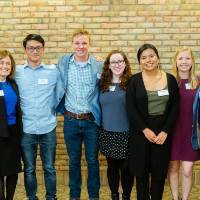 Jim Brooks posing with students at Scholarship Dinner 2019